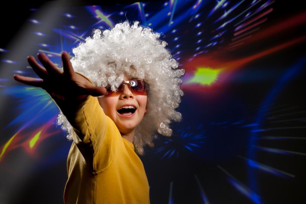 Canva - Child in glasses and a wig dances in disco lights.jpg